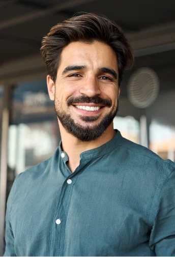 Man smiling while receiving dental care